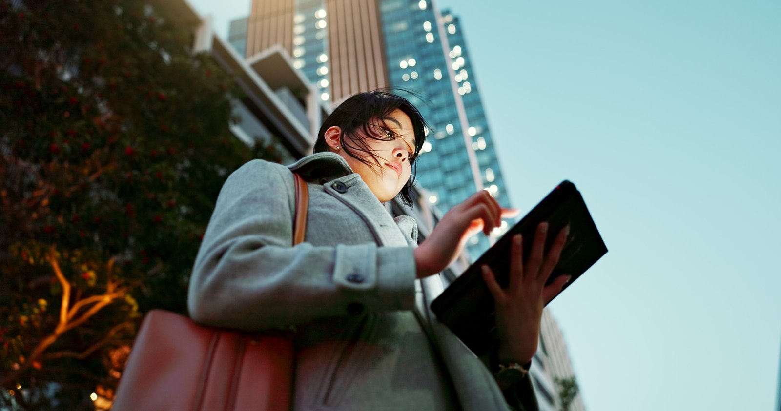 Asian woman, tablet and city for communication, research or social media by building in Japan. Fema